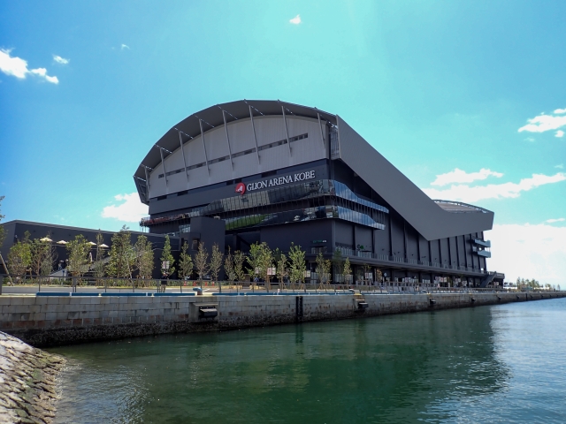 GLION ARENA KOBE seen from the waterfront under a clear blue sky