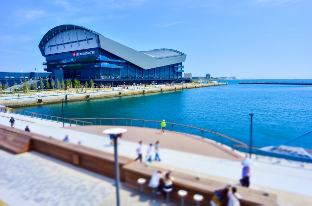 Harbor promenade and GLION ARENA KOBE by the waterfront with blue water