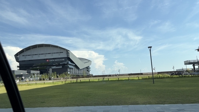 GLION ARENA KOBE exterior with a wide grassy lawn under a bright sky