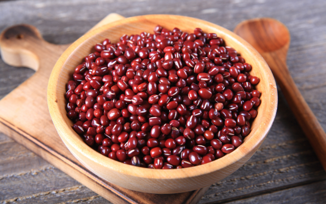 Red beans in a wooden bowl on a table