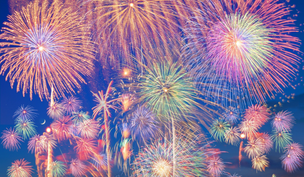 Colorful fireworks filling the blue night sky