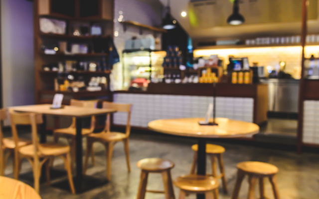 A cozy cafe interior with tables and a counter