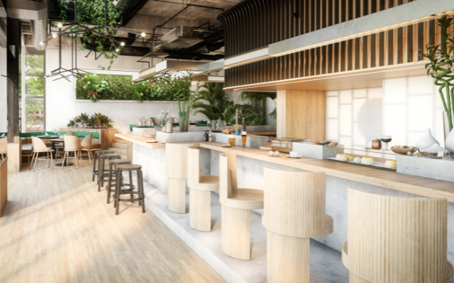 A modern cafe with a long counter, wooden stools, and greenery