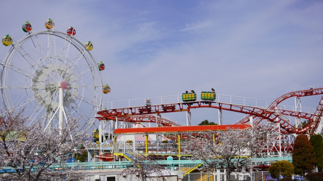 The amusement area at Kobe Fruit Flower Park Ozo with a ferris wheel and a roller coaster