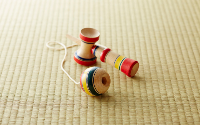 A kendama toy placed on tatami mat flooring